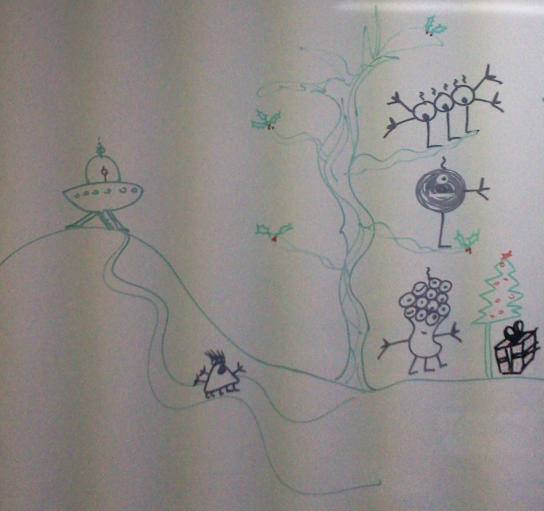 A crude drawing on a classroom whiteboard of a tree in green marker, with some strange-looking aliens of various shapes and with lots of googly eyes, coming from their flying saucer to the left of the picture to examine a small christmas tree with a large present on the right