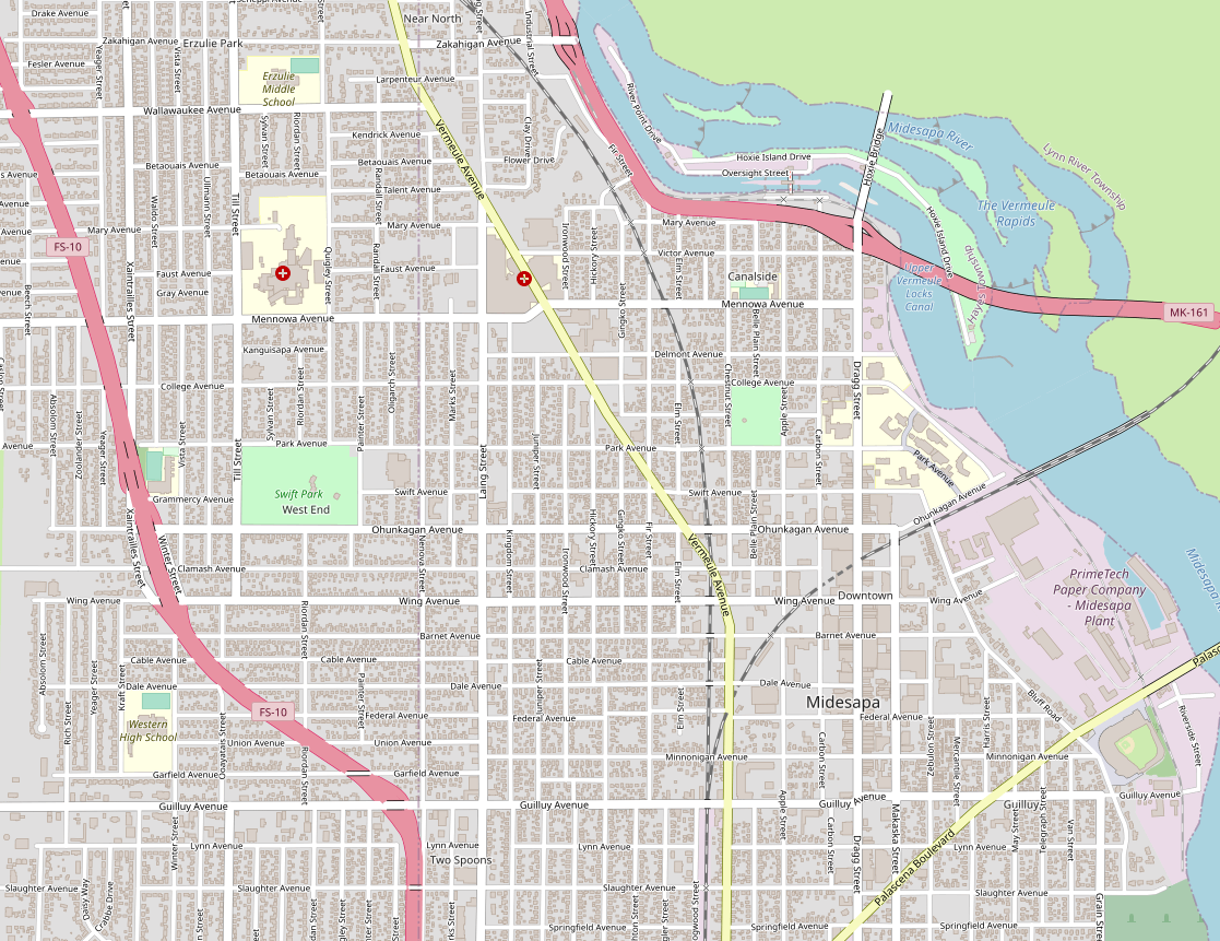 Screenshot of the map window on the OpenGeofiction site, showing an urban area mapped along a river running from south to north, with lots of detail, including some freeways and a paper mill and locks and rapids along the river